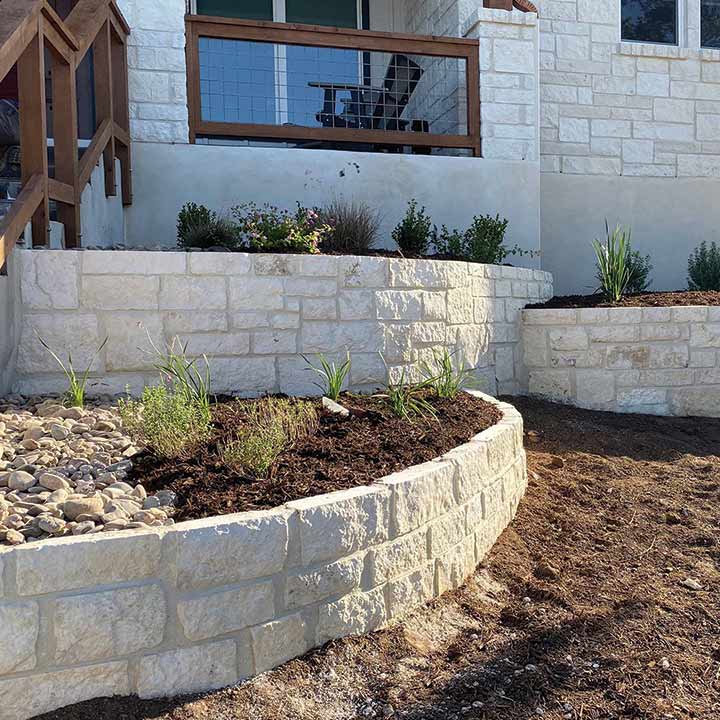 white limestone with individual flower beds
